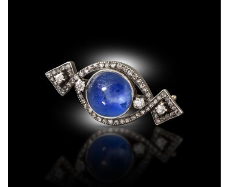 Fabergé - A sapphire and diamond brooch, set with a circular cabochon sapphire within twisted borders of diamonds in silver a