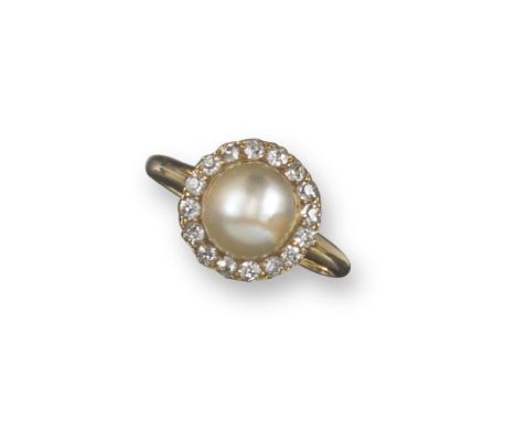 An early 20th century natural pearl and diamond cluster ring, the central pearl set within a surround of diamonds in yellow g