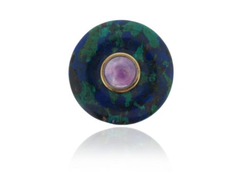 A circular azurite malachite brooch, set with a central amethyst cabochon in silver and gold collet, with silver fittings to 
