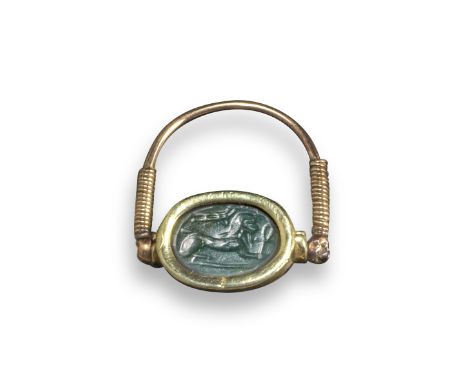 A green jasper Egyptian scarab intaglio, c. 500-600 BC, mounted in a later gold swivel ring, scarab 1.5cm wide, ring size M 1