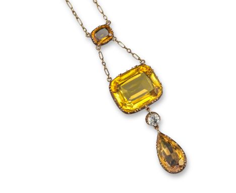 An Edwardian citrine and white sapphire pendant, the graduated cushion-shaped citrines suspend a white sapphire and pear-shap