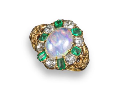 A Victorian opal, emerald and diamond cluster ring, the oval opal cabochon is set within a surround of emeralds and diamonds 