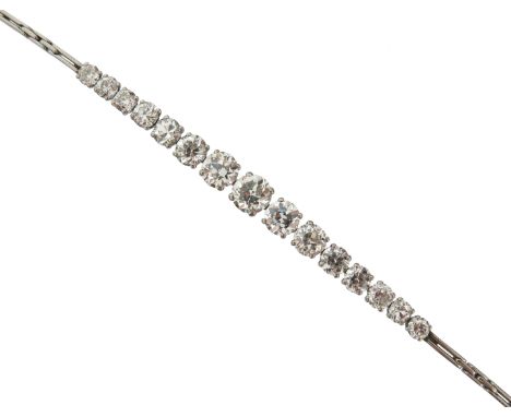 An early 20th century diamond bracelet, set with graduated old circular-cut diamonds in platinum, with safety chain, 16cm lon
