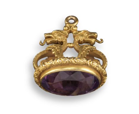 A Regency amethyst-set gold fob seal, the scrolling mount designed with the busts of two dragons, with further foliate decora