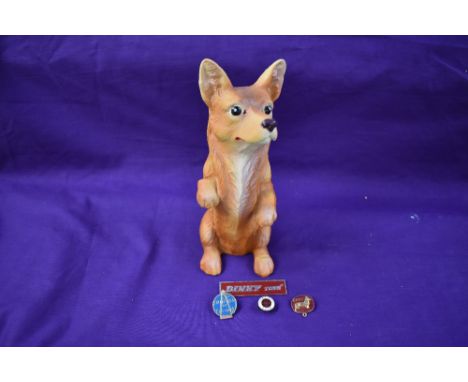 A composition Corgi  shop advertising dog and four advertising enamel badges, Corgi, Dinky and Spot On