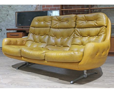 A Parker Knoll(?) retro mustard yellow buttoned sofa on aluminium legs, length 196cm, depth 86cm & height 93cm.