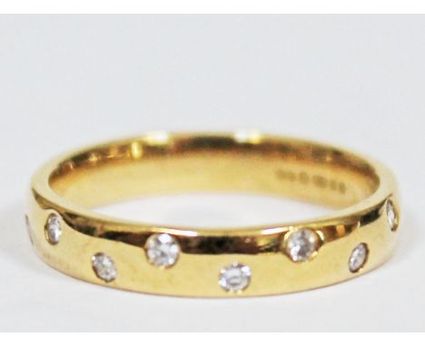 A contemporary 18ct gold diamond wedding ring, hallmarked, gross wt. 3.6g, size K.