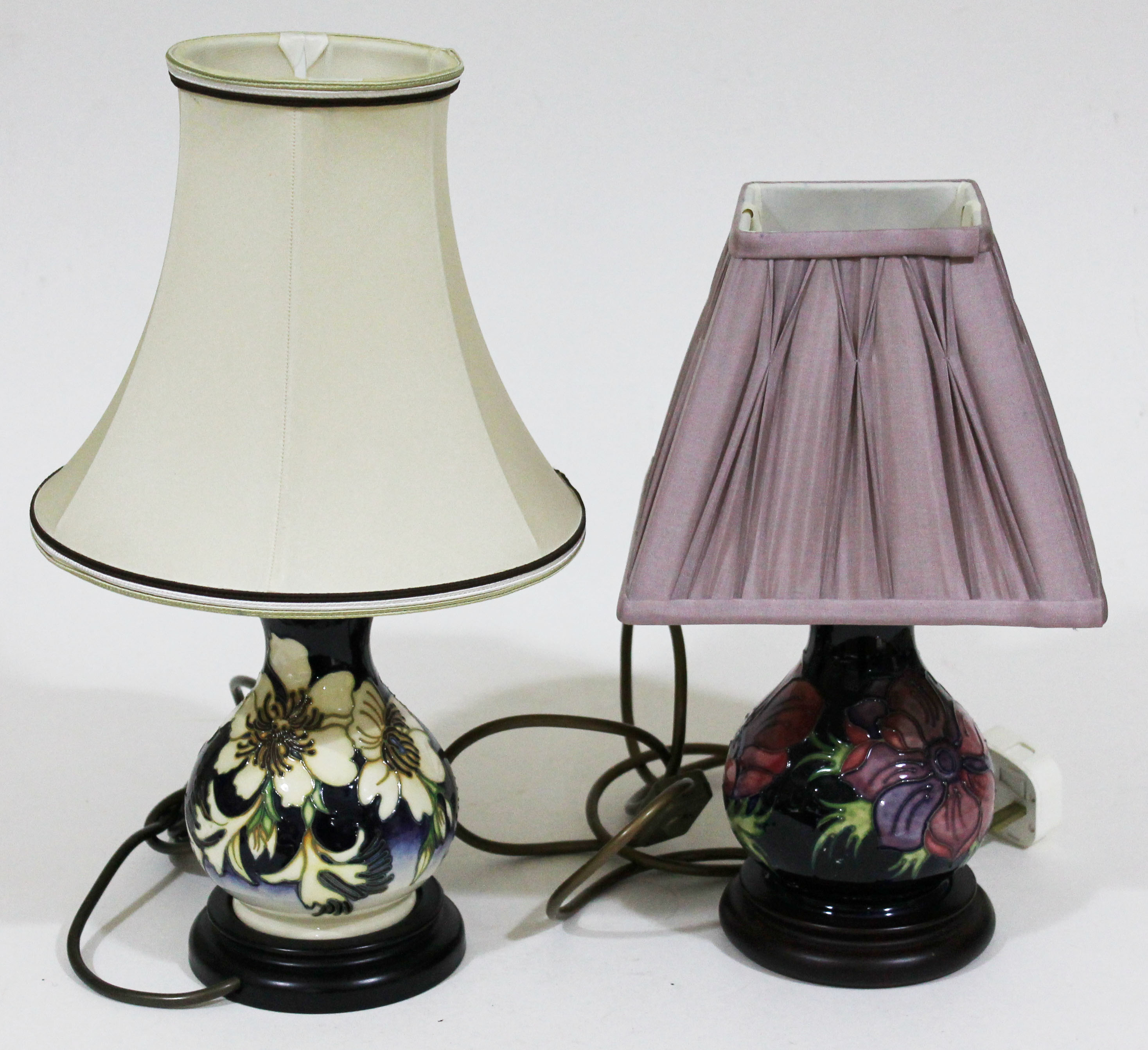 Two Moorcroft pottery table lamps, height 33cm & 39cm (including shades).