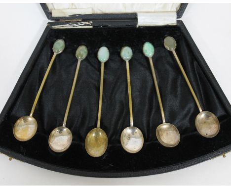 A cased set of six Arts & Crafts style tea spoons with jade cabochon finials, unmarked, length 10.5cm each.