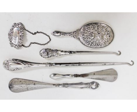 A mixed lot comprising hallmarked silver button hooks and shoe horns, a hallmarked silver decanter label and a white metal ba