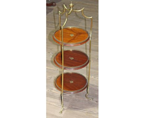 An Edwardian Arts & Crafts style brass framed and mahogany three tier plant stand, cast 'SH&S' to frame, height 84cm.