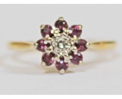 A diamond amethyst flower head ring, diam. 9mm, marked '18ct', gross wt. 3.3g, size N.
