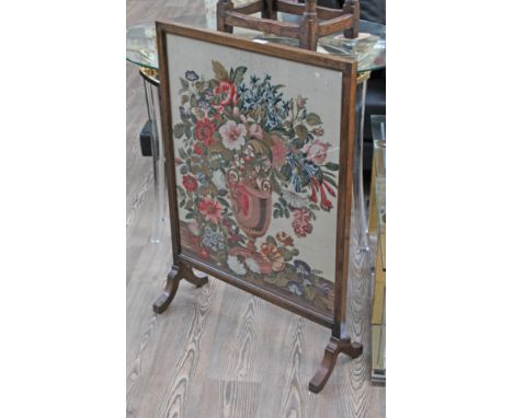 A Victorian oak framed needlework firescreen, height 94cm.