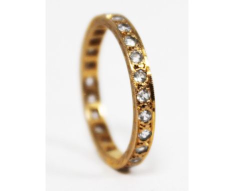 A yellow metal diamond eternity ring, gross wt. 2.5g, size R/S.