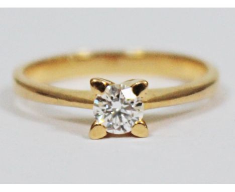 A diamond solitaire ring, the four point set diamond approx. 0.25 carats, band marked '750', gross wt. 2.5g, size K, diamond 