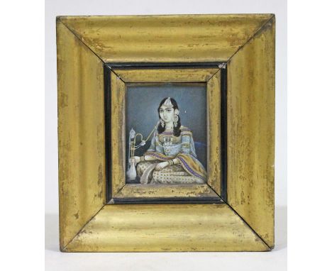 Indian School 19th Century, miniature portrait on ivory depicting a girl smoking from a pipe, glazed and framed 13.5cm x 14.5