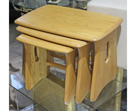 An Ercol light elm nest of tables.