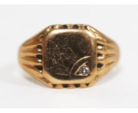 A hallmarked 9ct gold signet ring set with a small diamond, gross wt. 5.2g, size S/T.