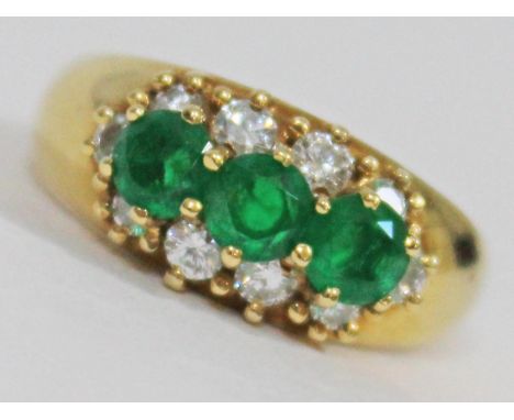 A diamond and emerald ring, marked '750' with import marks, gross wt. 4.4g, size K. Condition - very good, appears damage/rep