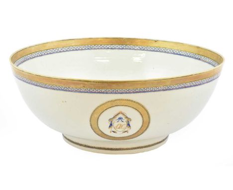 A Chinese Porcelain European Market Punch Bowl, circa 1800, painted in underglaze blue and gilt with shield and swag cartouch