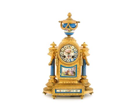 A Gilt Metal Porcelain Mounted Striking Mantel Clock, circa 1890, case surmounted with an urn finial, blue porcelain front pa