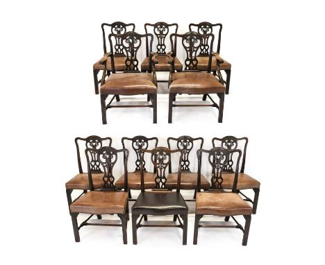 A Set of Twelve (10+2) George III Style Carved Mahogany Dining Chairs, late 19th century, covered in close-nailed light brown