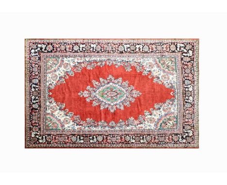 Mahal CarpetWest Iran, circa 1940The plain blood red field centred by a floral medallion framed by spandrels and enclosed by 