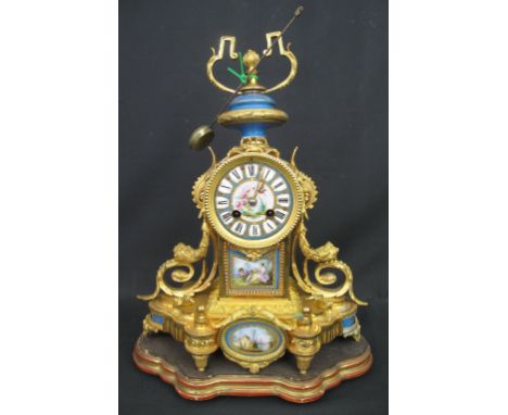 19TH CENTURY FRENCH ORMOLU TWO TRAIN, PORCELAIN MOUNTED MANTEL CLOCK in Classical style with urn shaped finial over Roman pai