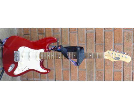 A Stagg electric guitar with stand & Levys strap