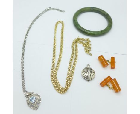 A jade bangle, a silver pendant and chain, a silver locket marked Atocka 1622, a pair of amber cufflinks and a gold plated ch