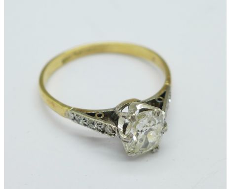 An 18ct gold and platinum set oval cut diamond ring, with diamond shoulders, 2.2g, Q/R