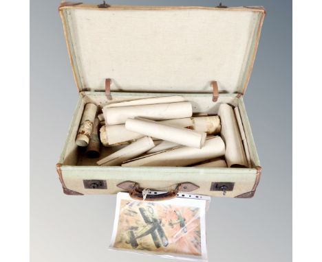 A vintage canvas leather bound trunk containing assorted rolled pictures and prints.