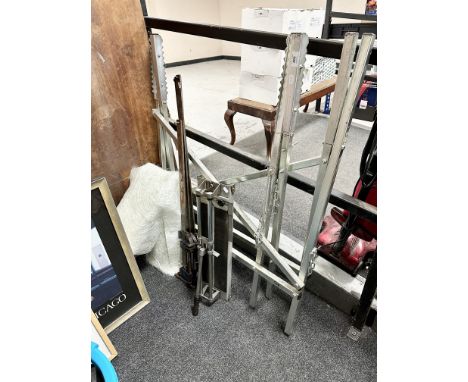 A folding sawhorse stand together with a tile cutter, three sash clamps, a roll of fibreglass padding and a mahogany counter 