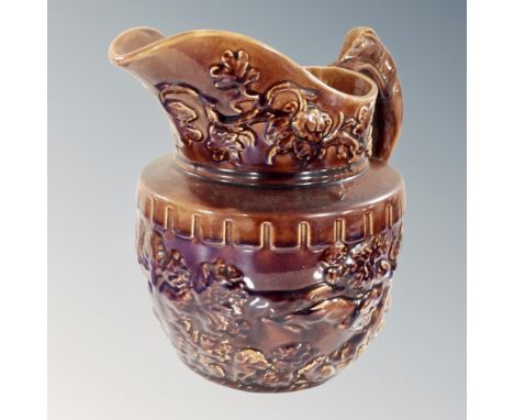 A vintage wood hound handle pottery embossed jug.