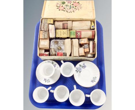 Six Chinese teacups and saucers together with a vintage tin containing assorted bulbs.
