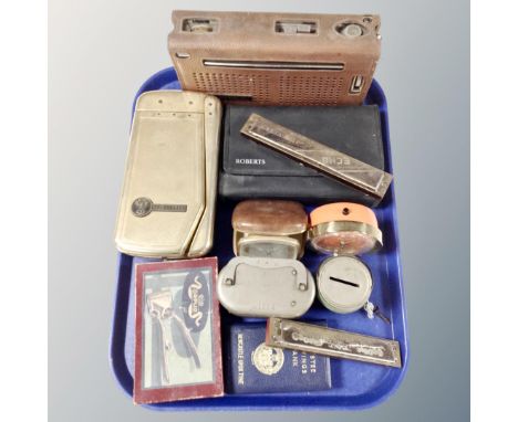 A tray containing mid-20th century money boxes and desk clocks, harmonicas, vintage radios, a boxed Orplid razor.