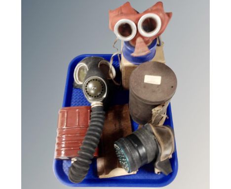 A tray containing vintage gas masks.