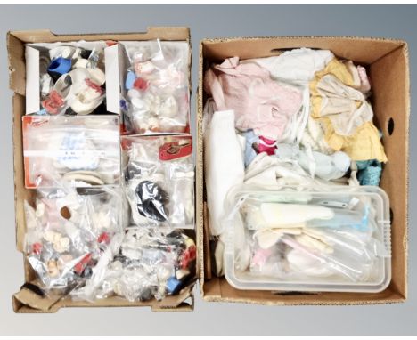 Two boxes containing a large quantity of vintage doll's clothes and shoes.