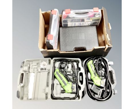 Three cased power tools including two Exact saws, a cased 12v electric drill with battery, charger and accessories, and two p
