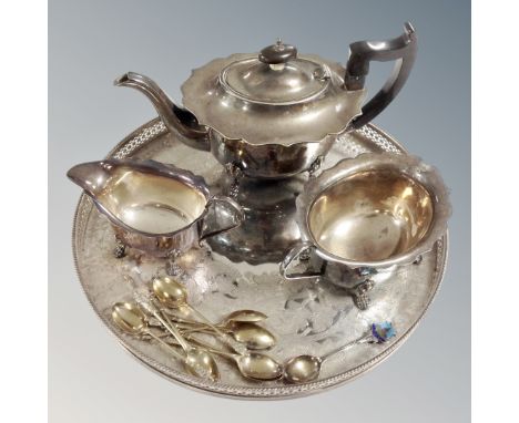 A three piece plated tea service on circular tray, together with a set of plated apostle spoons and a silver Norwich crested 