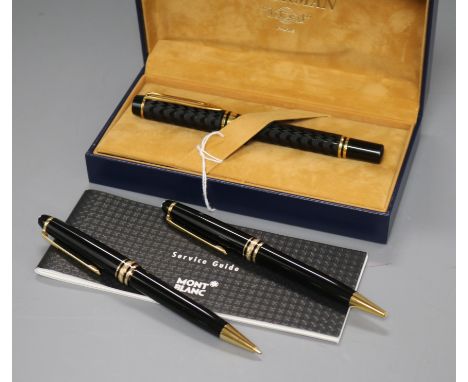 A Montblanc Meisterstuck black and gold ballpoint/propelling pencil set and a Waterman fountain pen in black and gold, with '