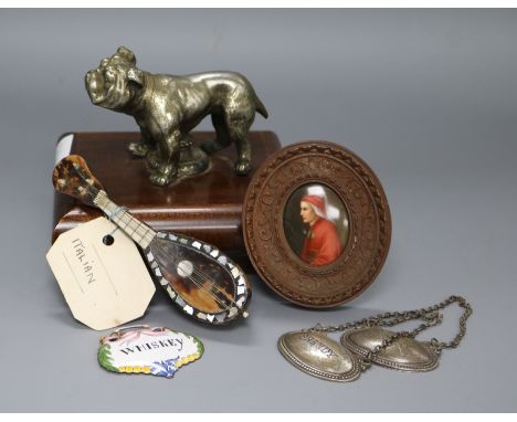 A dog paperweight, a miniature mandolin, three spirit labels, miniatures and ceramic plaque