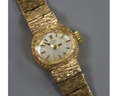 A lady's textured 9ct gold Rotary manual wind wrist watch.
