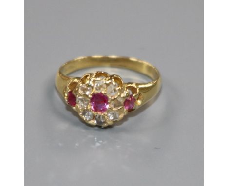 A small early 20th century ruby and rose cut diamond set cluster ring, size G.