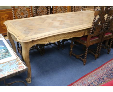 A 19th century French parquetry top dining table, on cabriole legs W.216cm