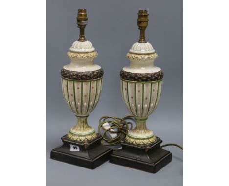 A pair of cream and green urn shaped table lamps