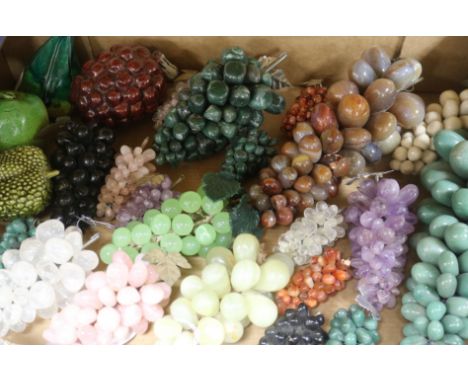 A collection of hardstone bunches of grapes and four ceramic models of fruit