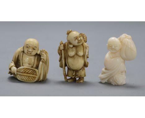 Three early 20th century Japanese netsuke of Hotei, two in ivory, one coral