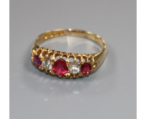 An Edwardian 18ct gold five stone ruby and diamond half hoop ring, size R.