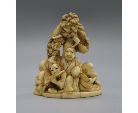 A Meiji period ivory okimono netsuke of rakan beneath a tree